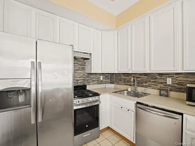 a kitchen with a sink stove and refrigerator