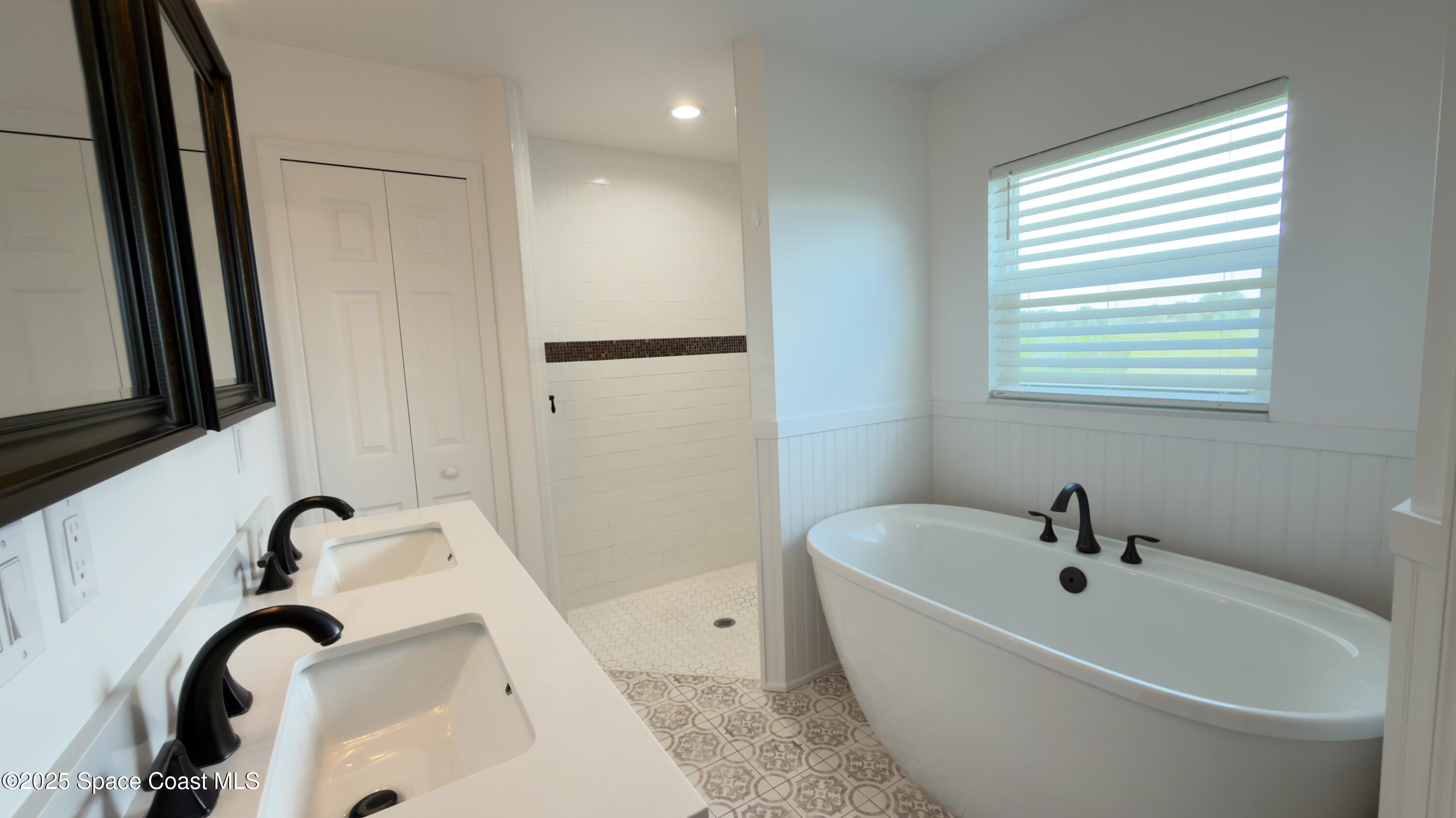1837 Ardmore Street Northeast Palm Bay, FL 32907 - Photo 11 of 23 a white bath tub sitting next to a sink