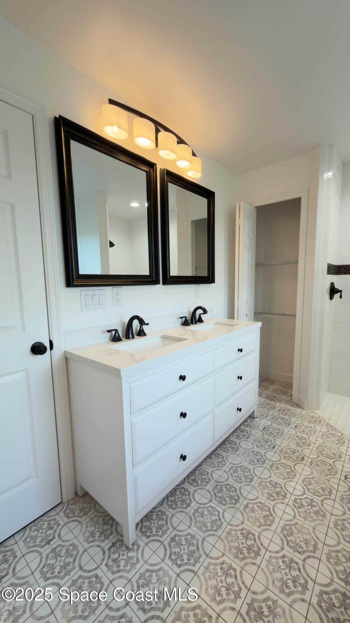 1837 Ardmore Street Northeast Palm Bay, FL 32907 - Photo 13 of 23 a bathroom with a sink mirror and vanity