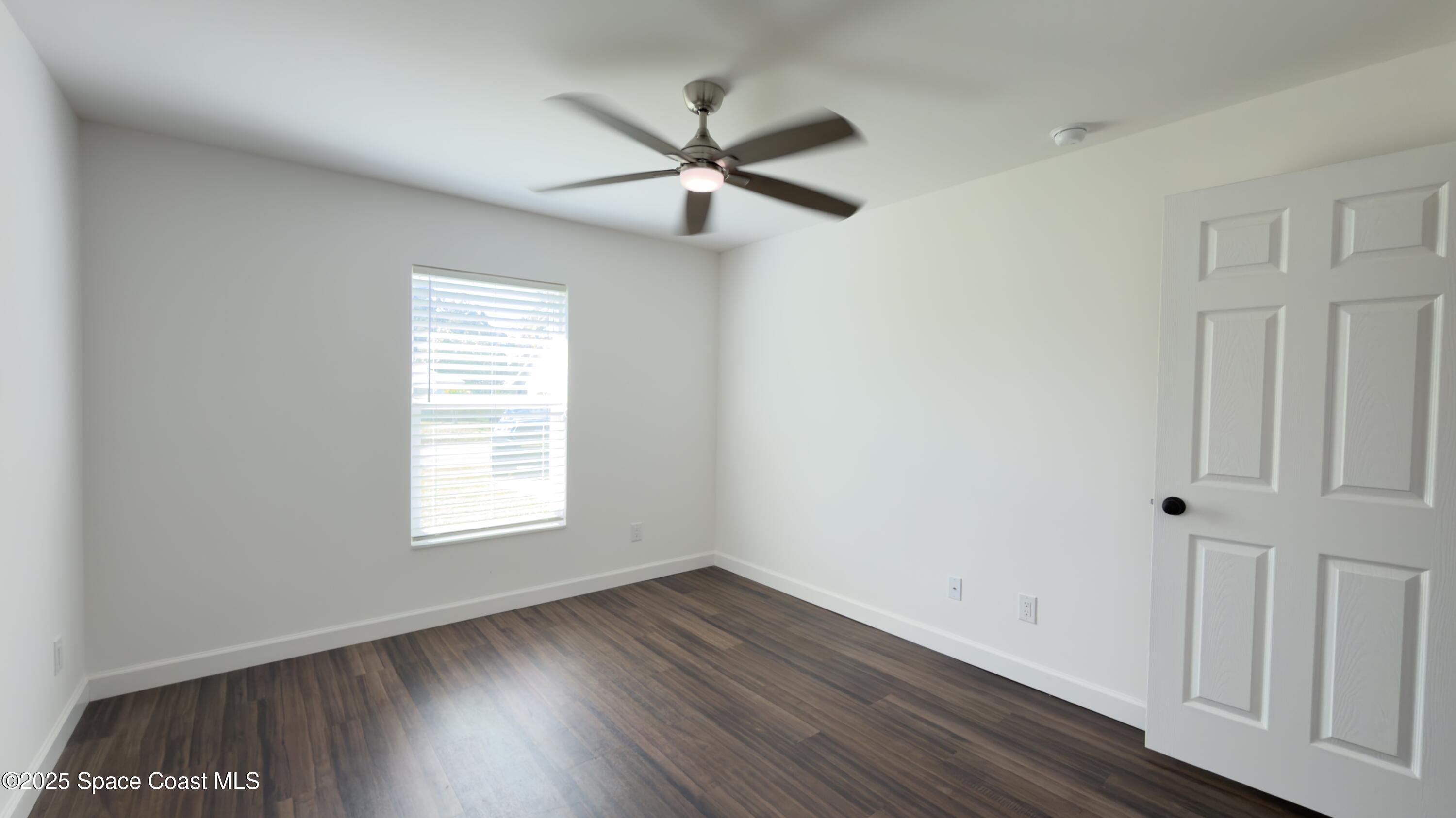 1837 Ardmore Street Northeast Palm Bay, FL 32907 - Photo 16 of 23 a view of empty room with wooden floor and fan