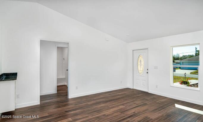 1837 Ardmore Street Northeast Palm Bay, FL 32907 - Photo 2 of 23 a view of an empty room with wooden floor and a window