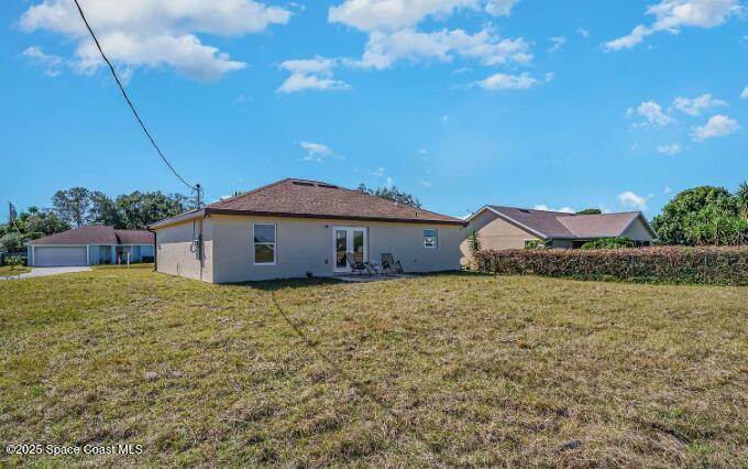 1837 Ardmore Street Northeast Palm Bay, FL 32907 - Photo 21 of 23 a house with green field