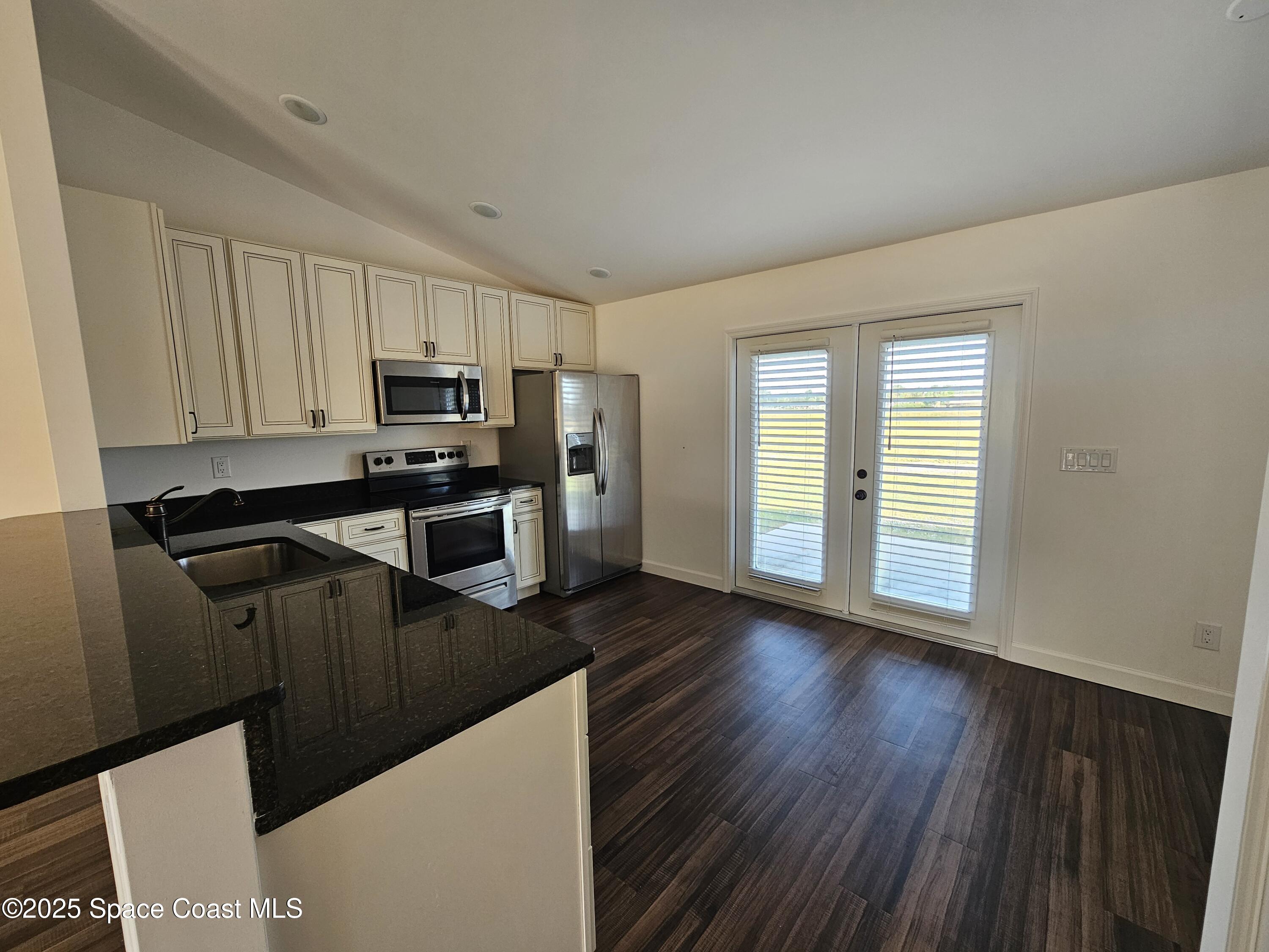 1837 Ardmore Street Northeast Palm Bay, FL 32907 - Photo 5 of 23 a kitchen with a refrigerator sink and cabinets