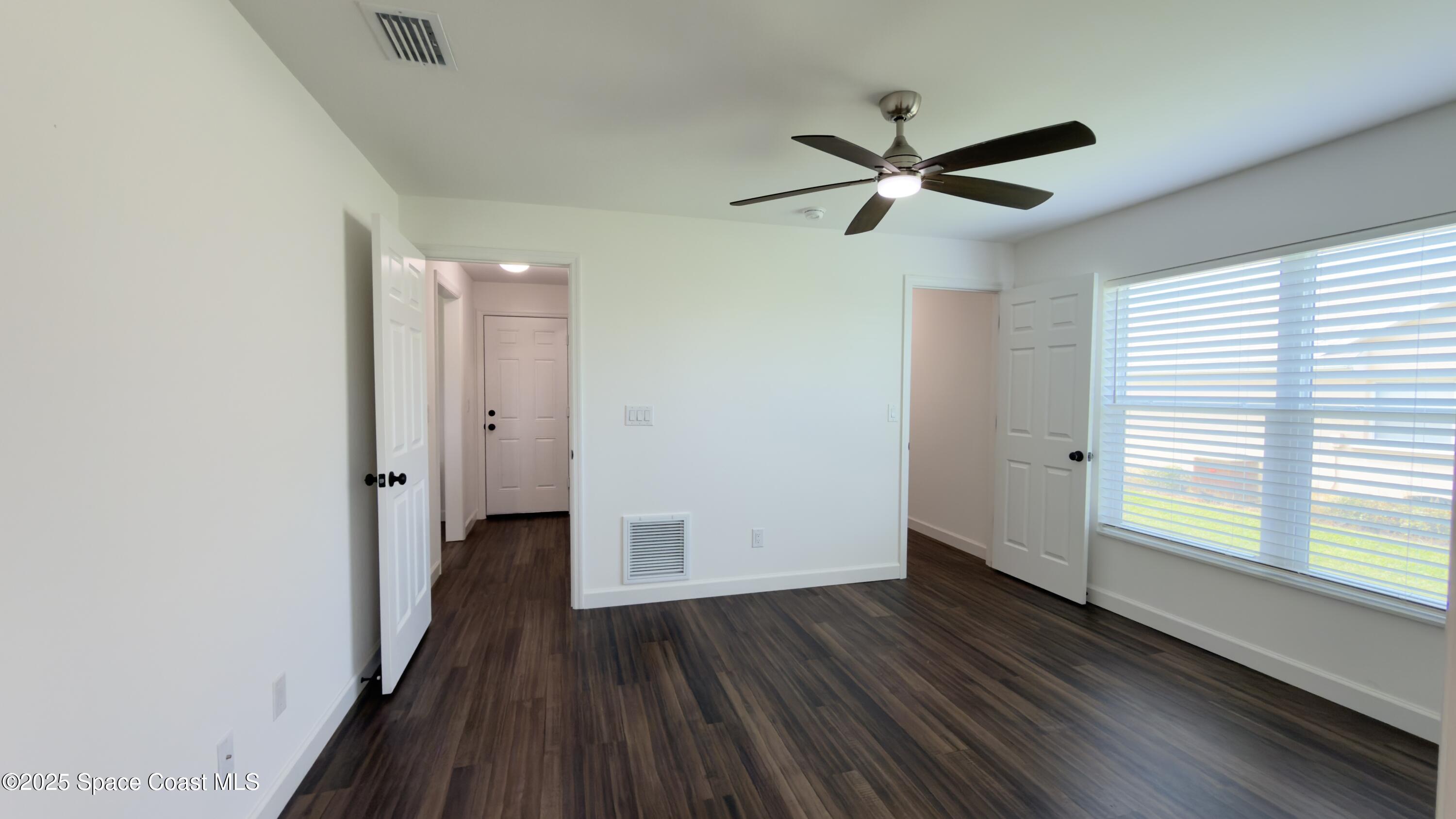 1837 Ardmore Street Northeast Palm Bay, FL 32907 - Photo 7 of 23 a view of empty room with wooden floor and fan