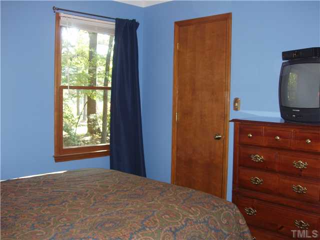 605 Riverview Road Raleigh, NC 27610 - Photo 9 of 19 a bedroom with a bed and a dresser