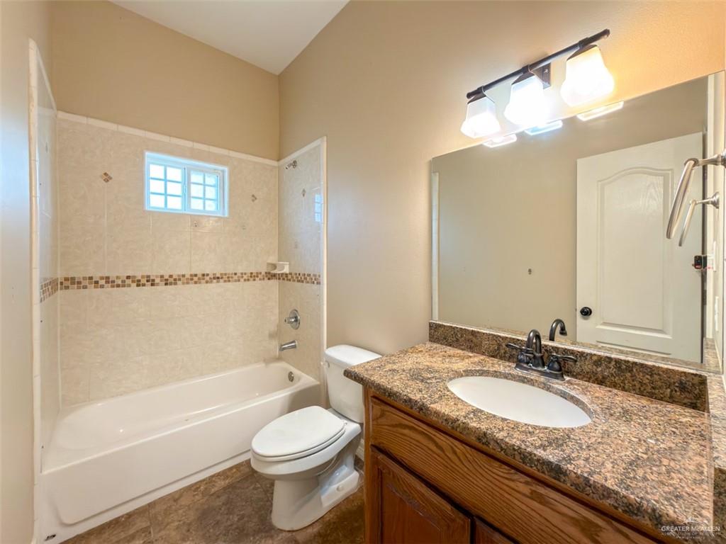 208 North 15th Street Hidalgo, TX 78557 - Photo 15 of 26 a bathroom with a granite countertop sink toilet and shower