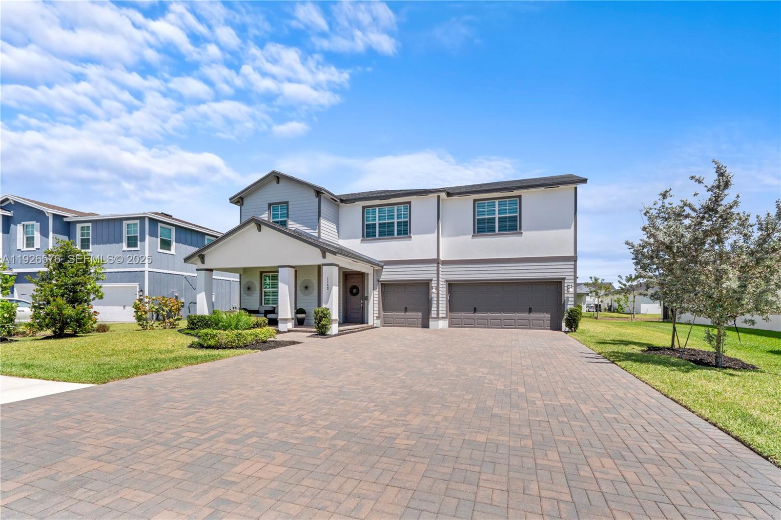 1162 Haywagon Trail Loxahatchee, FL 33470 - Photo 3 of 48 a front view of a house with a yard and garage