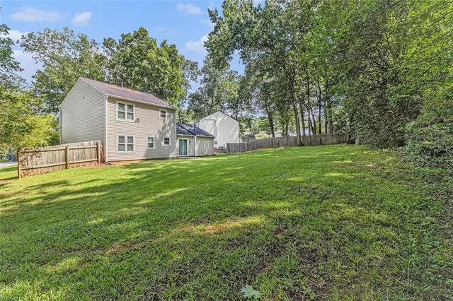 a view of a house with a yard and sitting area