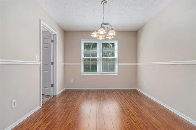 a view of wooden floor and windows in a room