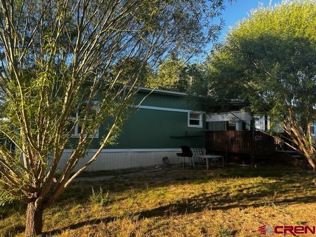 24020 Rd F 5, Unit 5 Cortez, CO 81321 - Photo 14 of 15 a view of backyard with a table and chairs and a large tree