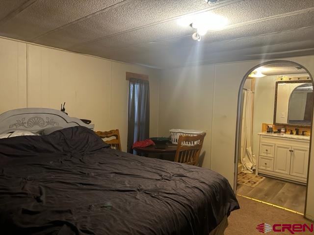 24020 Rd F 5, Unit 5 Cortez, CO 81321 - Photo 7 of 15 a bedroom with a bed and a mirror