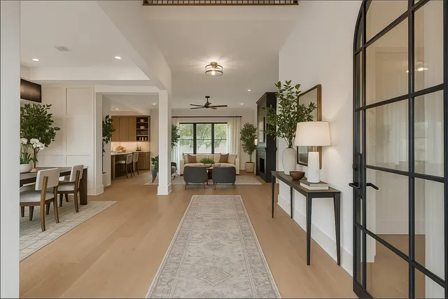 a large kitchen with stainless steel appliances a large counter top a stove a chimney a sink and a refrigerator