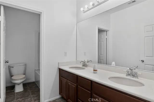a bathroom with a double vanity sink and a mirror