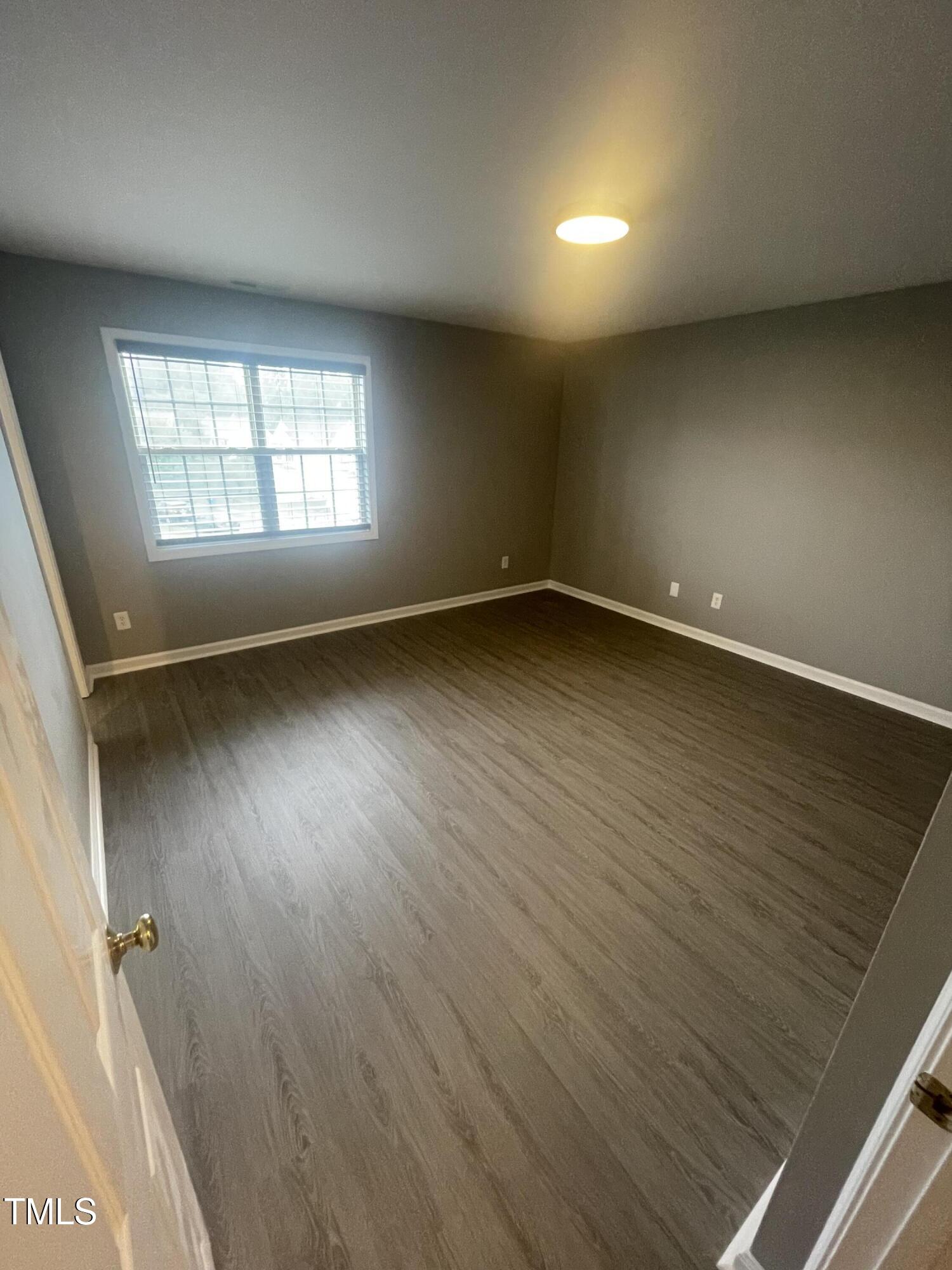 4201 Beacon Crest Way Raleigh, NC 27604 - Photo 11 of 21 an empty room with wooden floor and windows