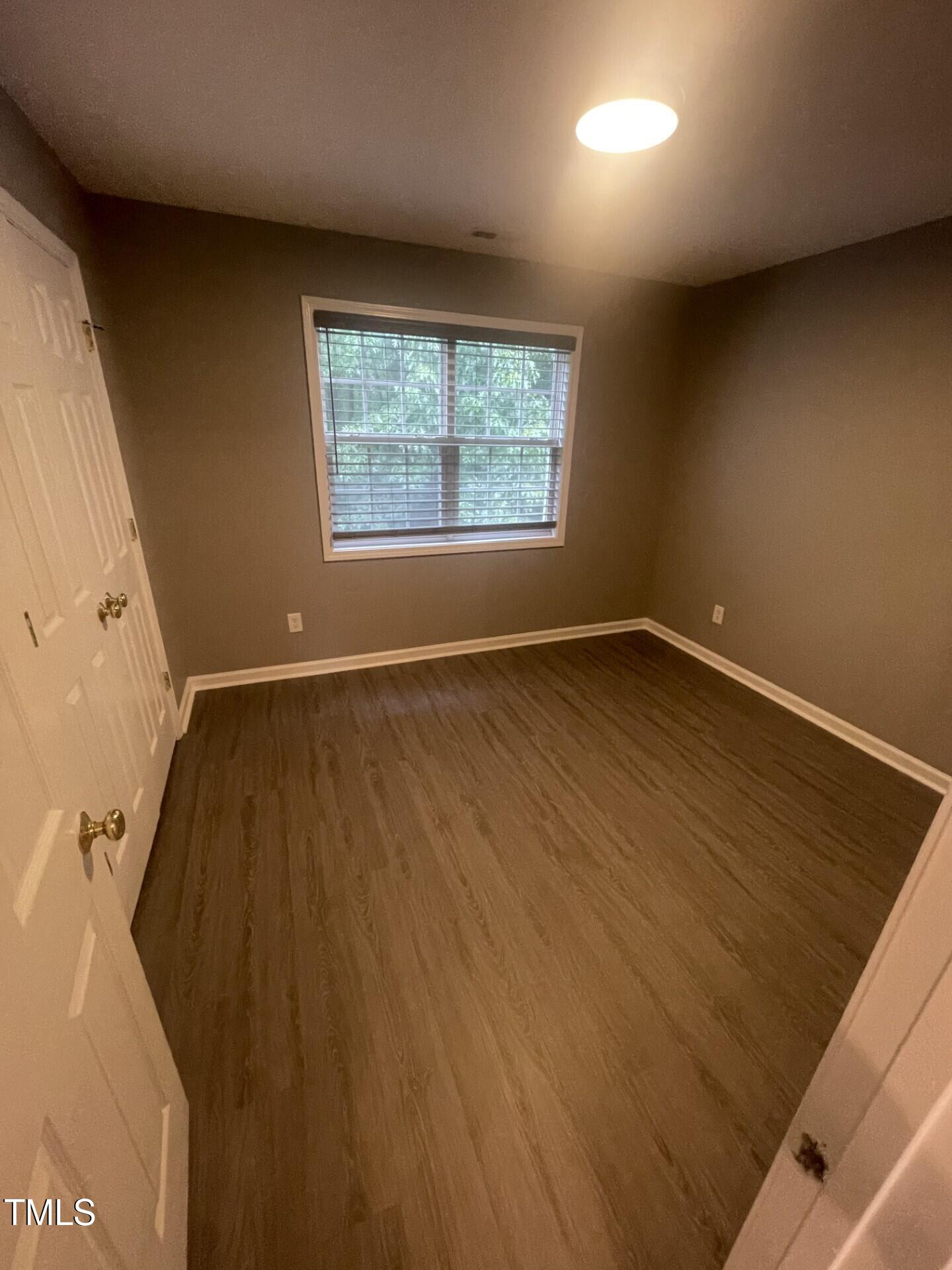 4201 Beacon Crest Way Raleigh, NC 27604 - Photo 13 of 21 an empty room with wooden floor and windows