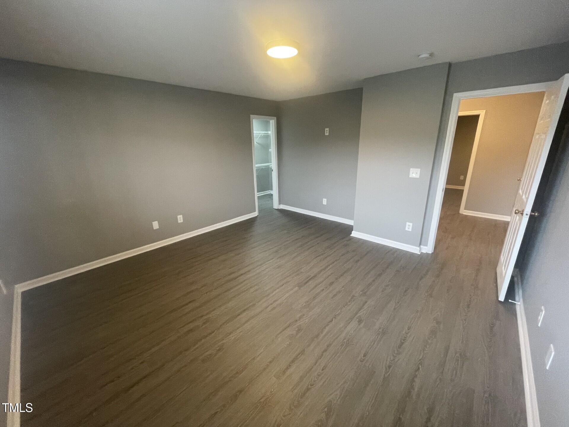 4201 Beacon Crest Way Raleigh, NC 27604 - Photo 20 of 21 an empty room with wooden floor and windows