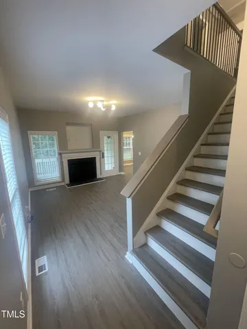 a view of entryway and hall with wooden floor