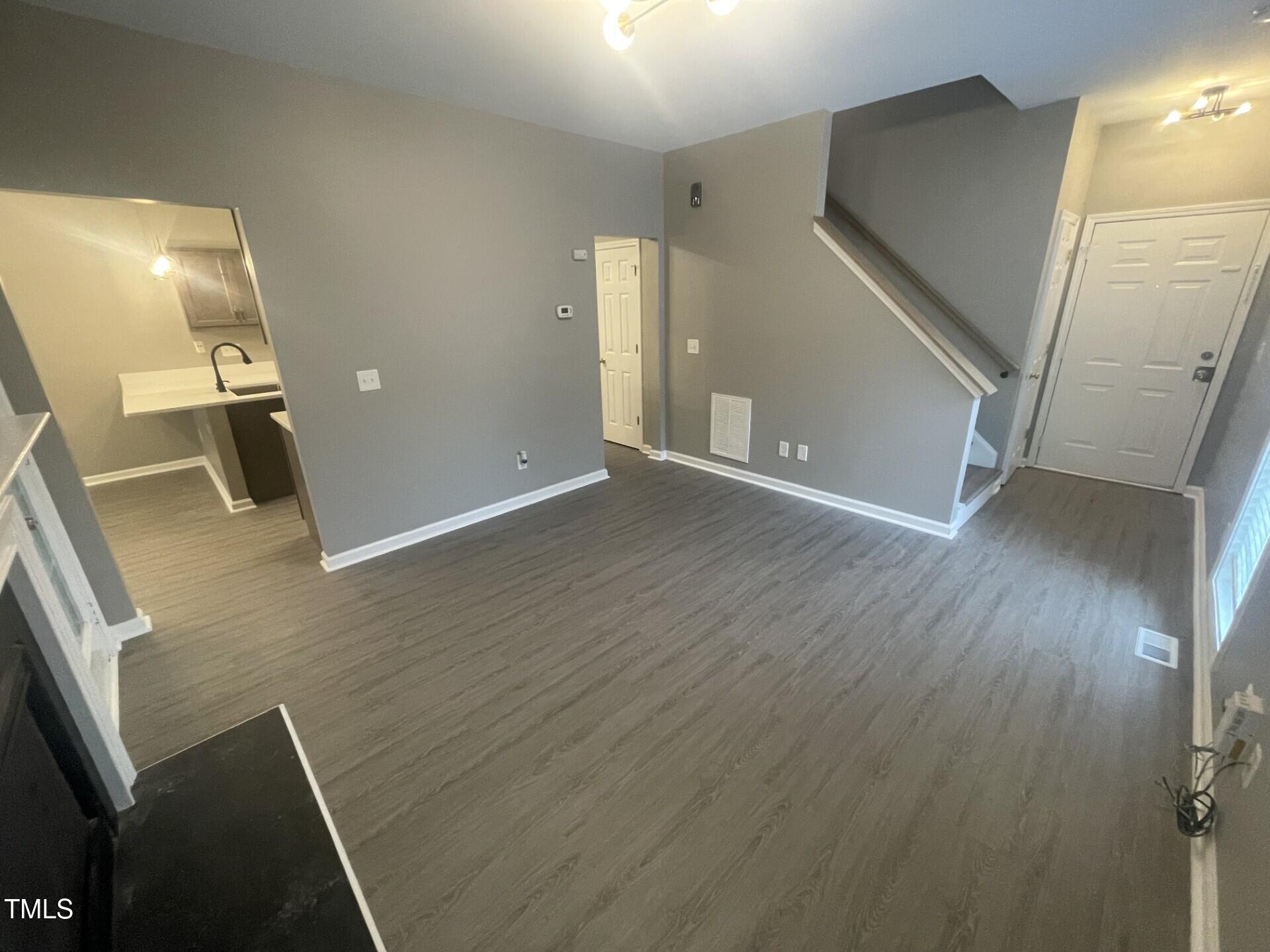 4201 Beacon Crest Way Raleigh, NC 27604 - Photo 5 of 21 a view of a livingroom with wooden floor and stairs