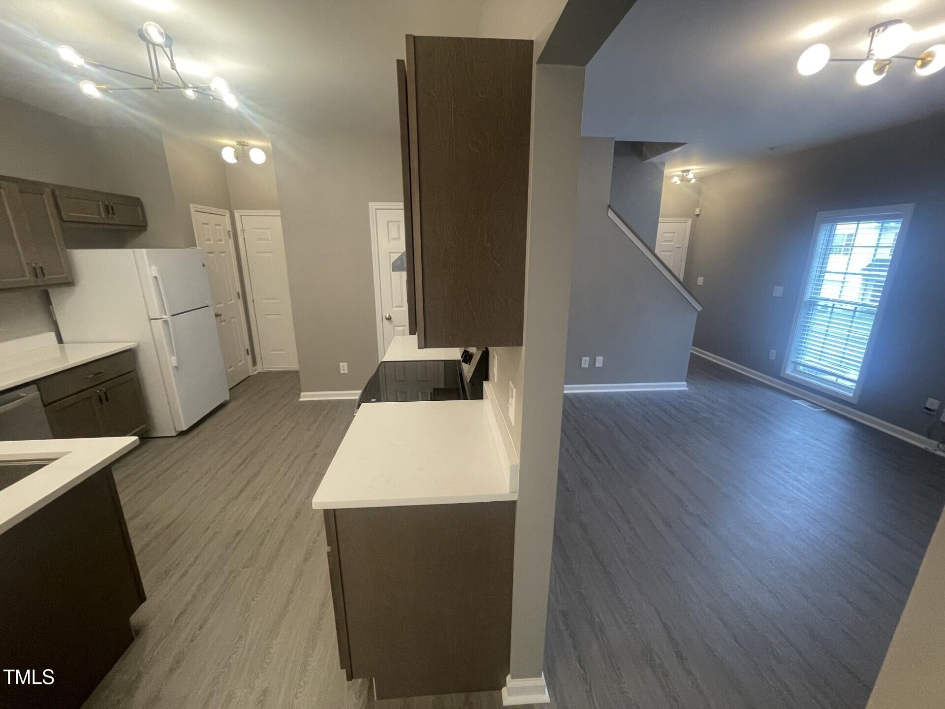 4201 Beacon Crest Way Raleigh, NC 27604 - Photo 6 of 21 a large white kitchen with a cabinetry and wooden floor