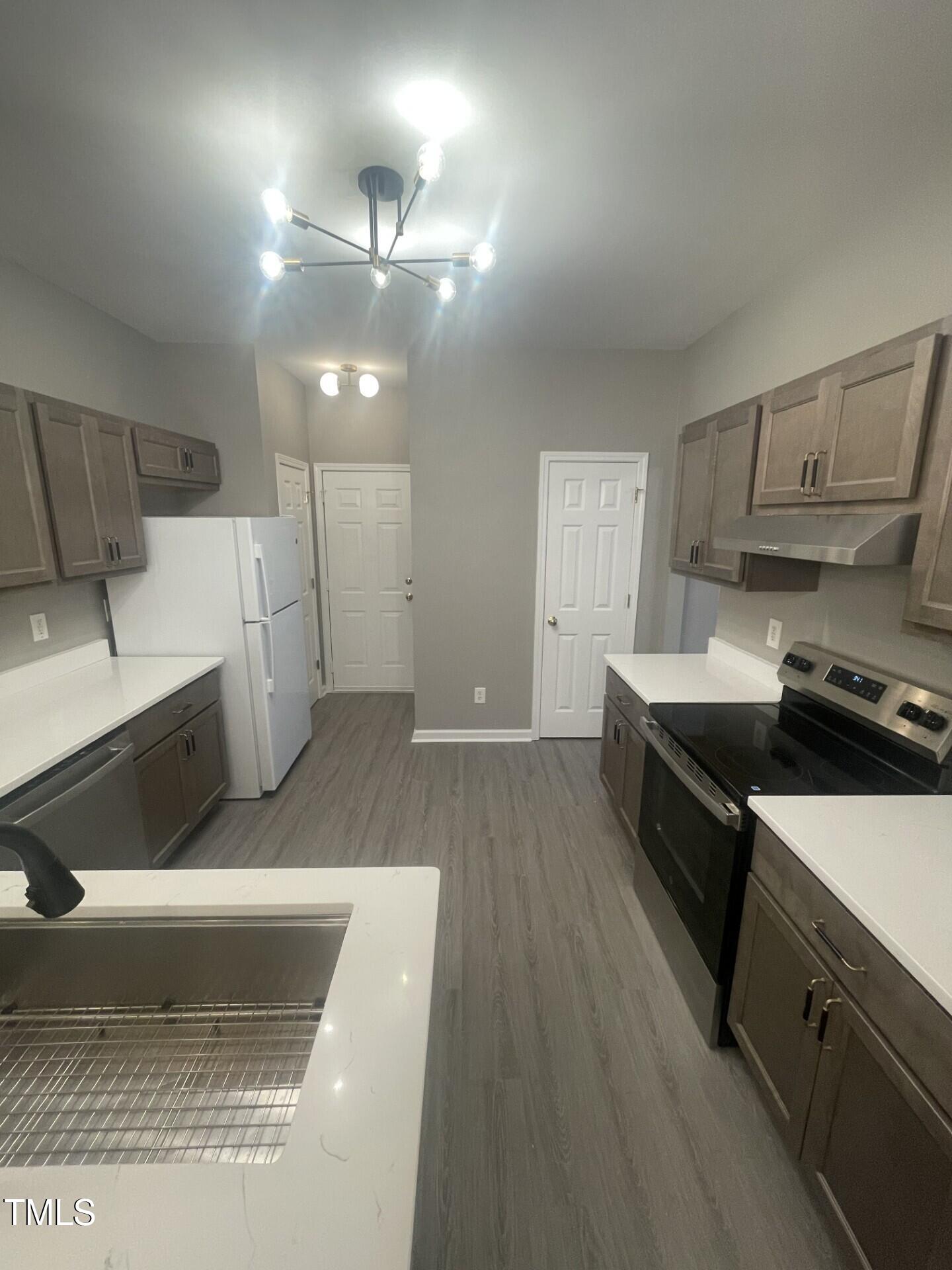4201 Beacon Crest Way Raleigh, NC 27604 - Photo 7 of 21 a kitchen with a sink and a stove top oven