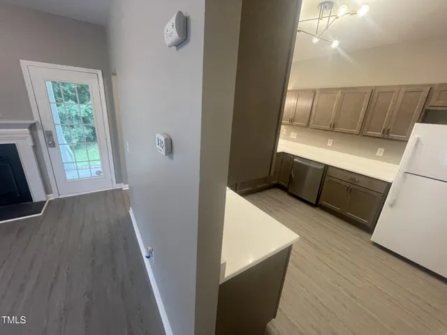 a view of washer and dryer with wooden floor