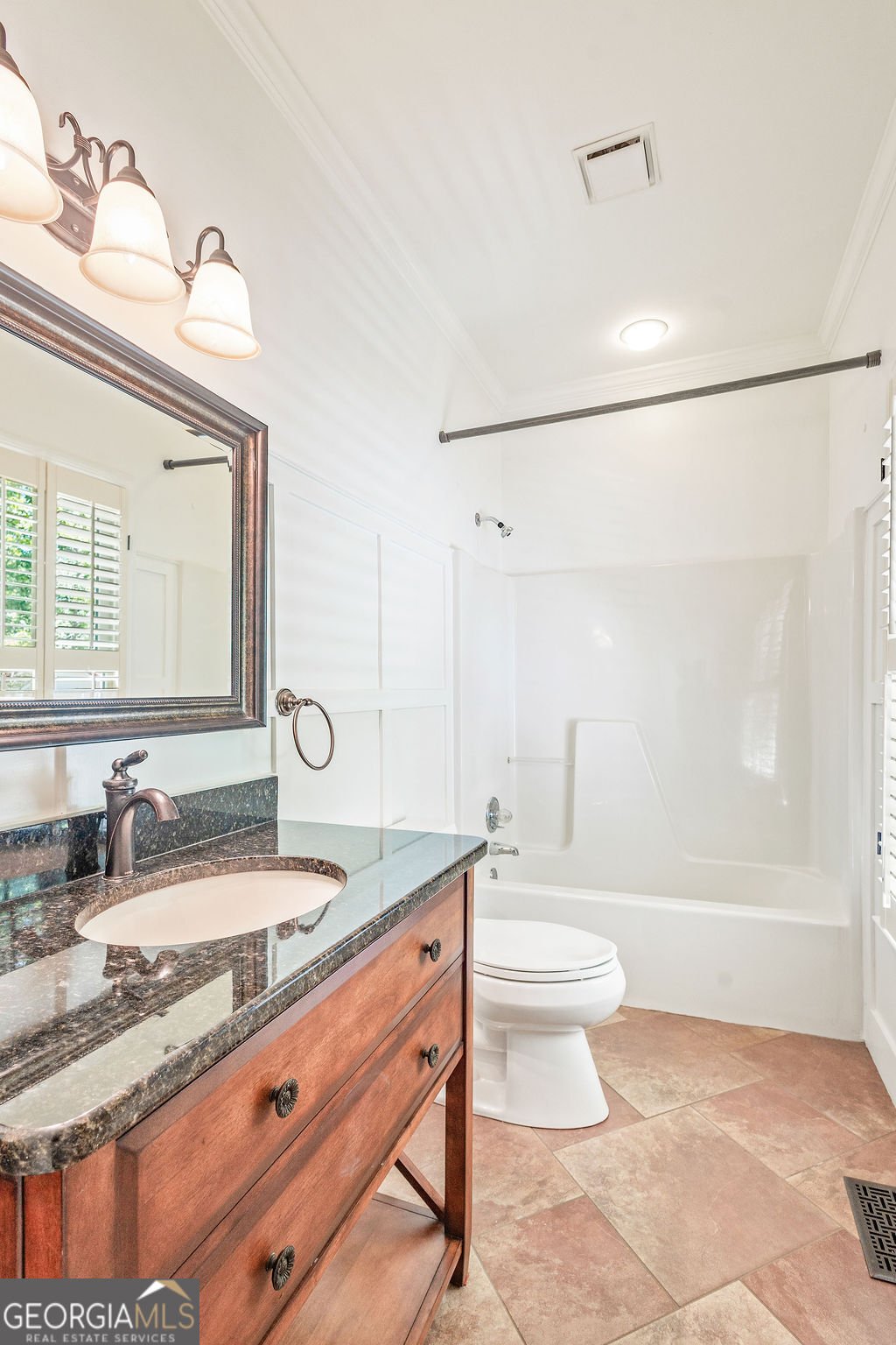 230 Haynes Road Moreland, GA 30259 - Photo 14 of 38 a bathroom with a granite countertop sink a toilet a mirror and bathtub