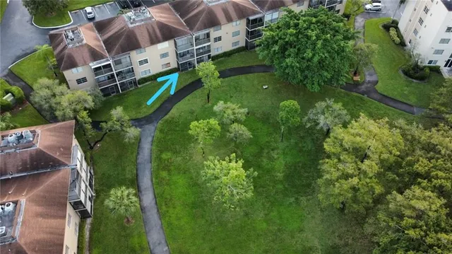 an aerial view of residential house with outdoor space and trees all around