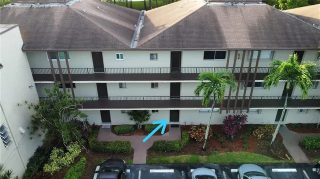 an aerial view of a house with table and chairs