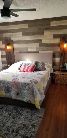 a bedroom with a bed and mirror