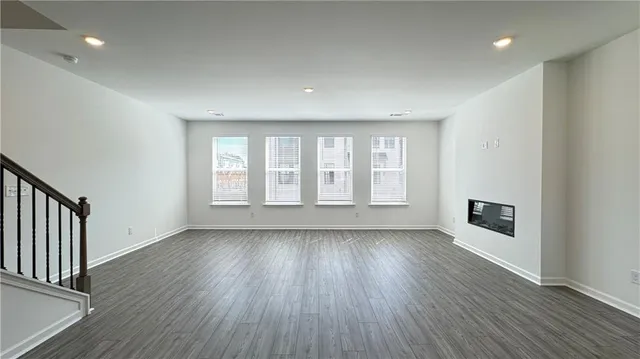 a view of an empty room with wooden floor