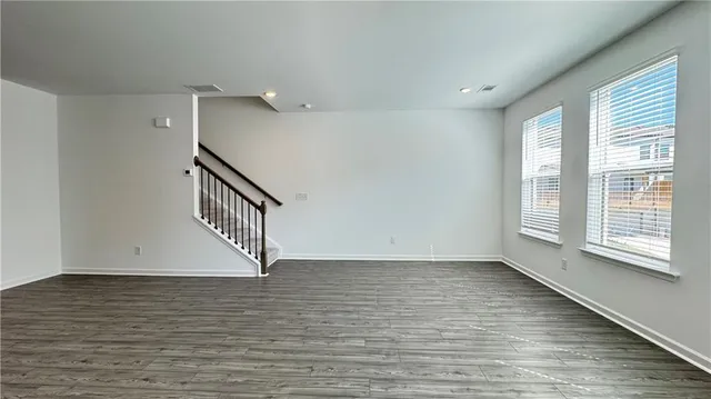 a view of a kitchen with furniture and wooden floor