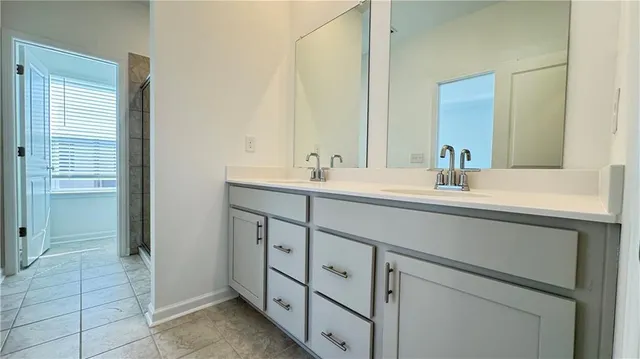 a bathroom with a double vanity sink and a mirror