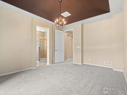 a view of a chandelier in big room and chandelier