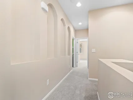 a view of hallway with bathroom