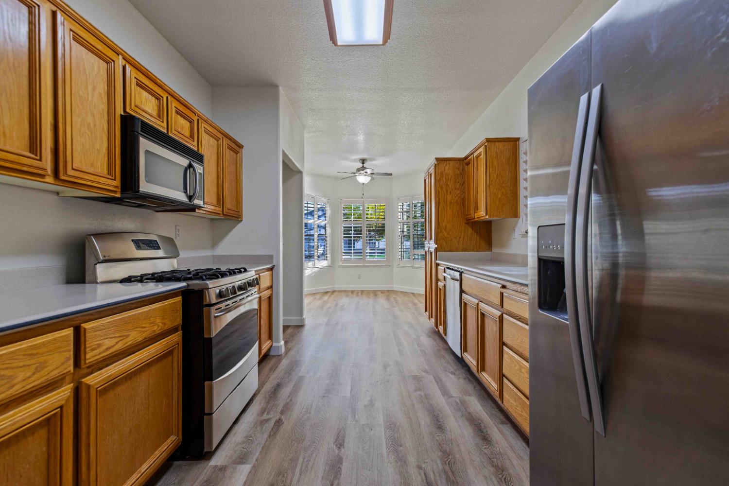 995 West Springer Drive Turlock, CA 95382 - Photo 11 of 39 a kitchen with stainless steel appliances granite countertop a refrigerator a stove top oven a sink and dishwasher
