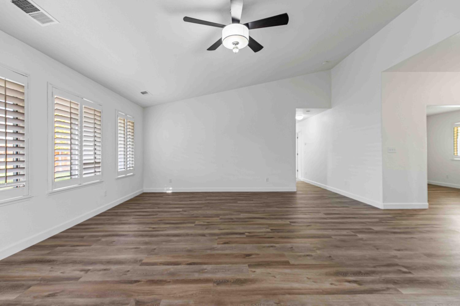 995 West Springer Drive Turlock, CA 95382 - Photo 15 of 39 wooden floor in an empty room with a window