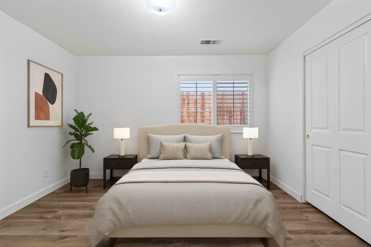 995 West Springer Drive Turlock, CA 95382 - Photo 19 of 39 a bedroom with a large bed a potted plant and a window