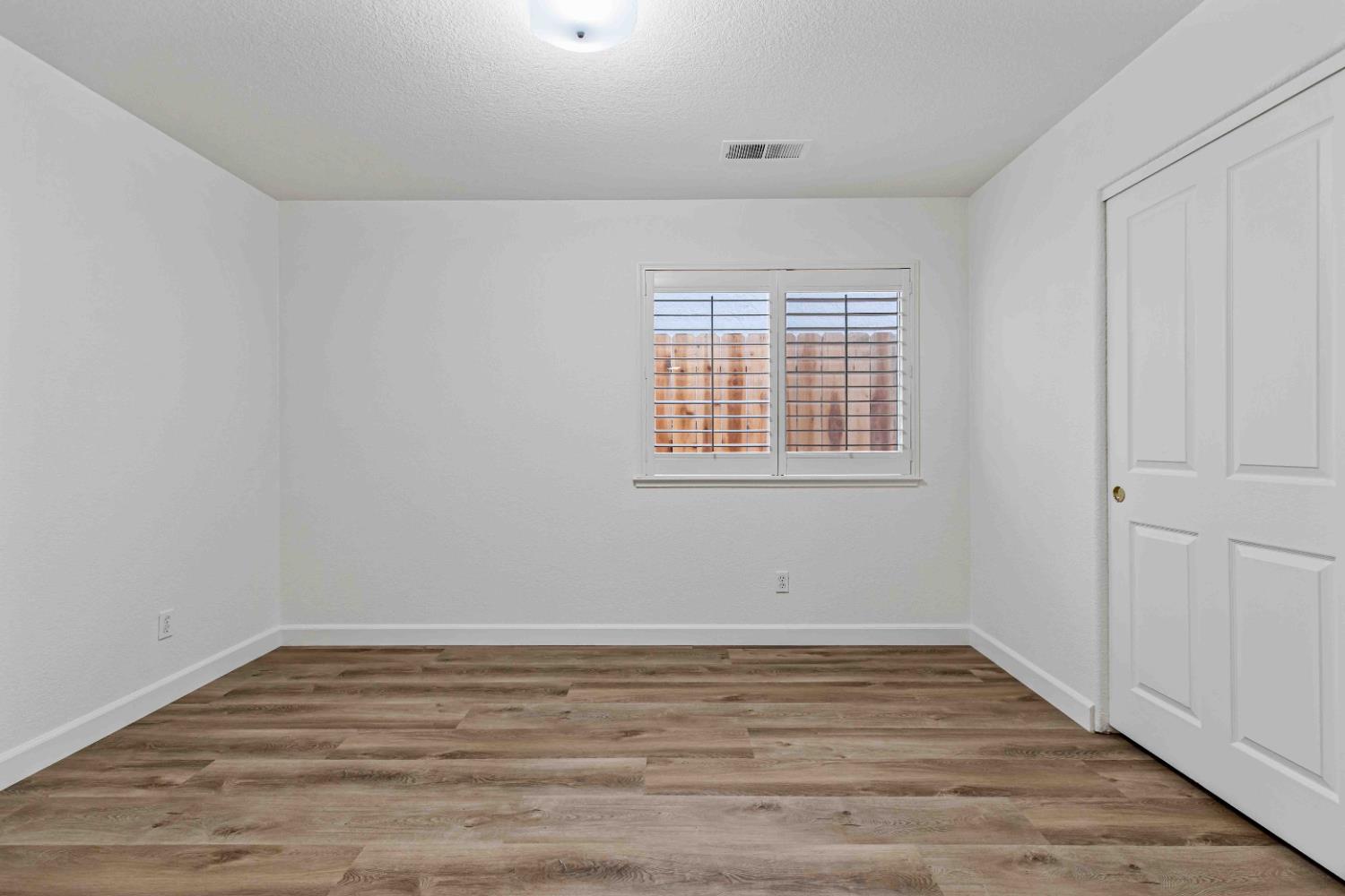 995 West Springer Drive Turlock, CA 95382 - Photo 20 of 39 wooden floor in an empty room with a window