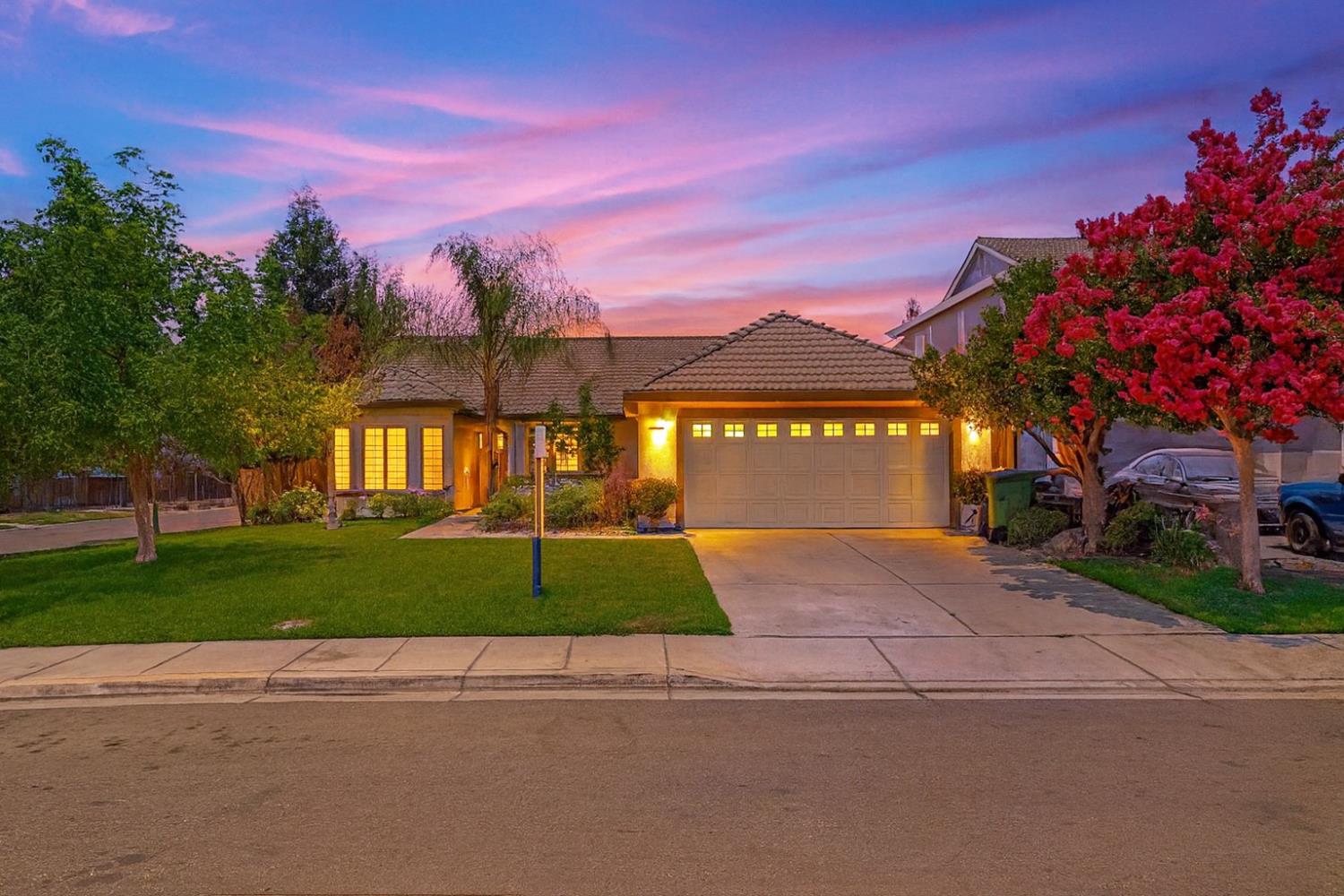 995 West Springer Drive Turlock, CA 95382 - Photo 2 of 39 a front view of a house with a yard and a garage