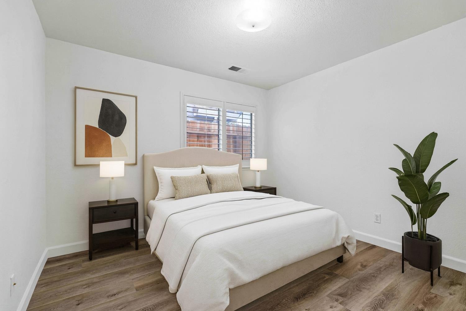 995 West Springer Drive Turlock, CA 95382 - Photo 22 of 39 a bedroom with a bed and a potted plant