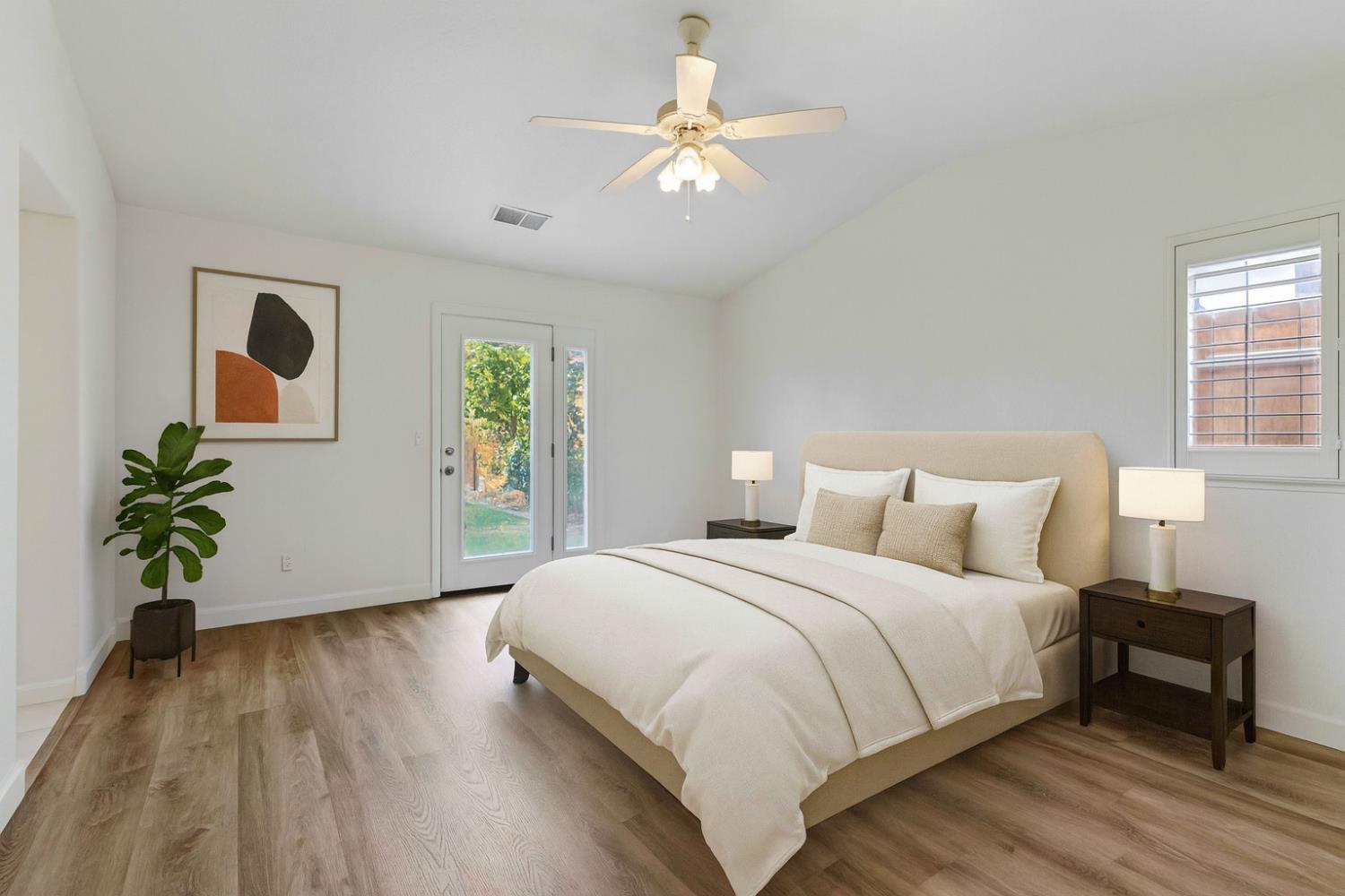 995 West Springer Drive Turlock, CA 95382 - Photo 25 of 39 a bedroom with a bed and a chandelier