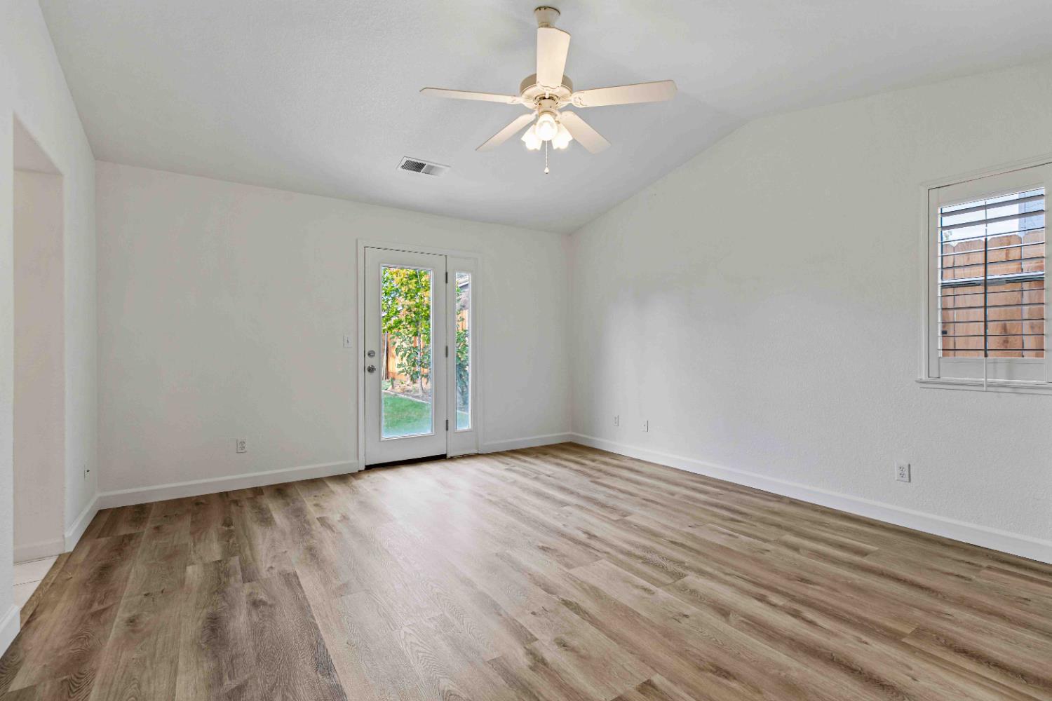 995 West Springer Drive Turlock, CA 95382 - Photo 26 of 39 a view of an empty room with window and wooden floor