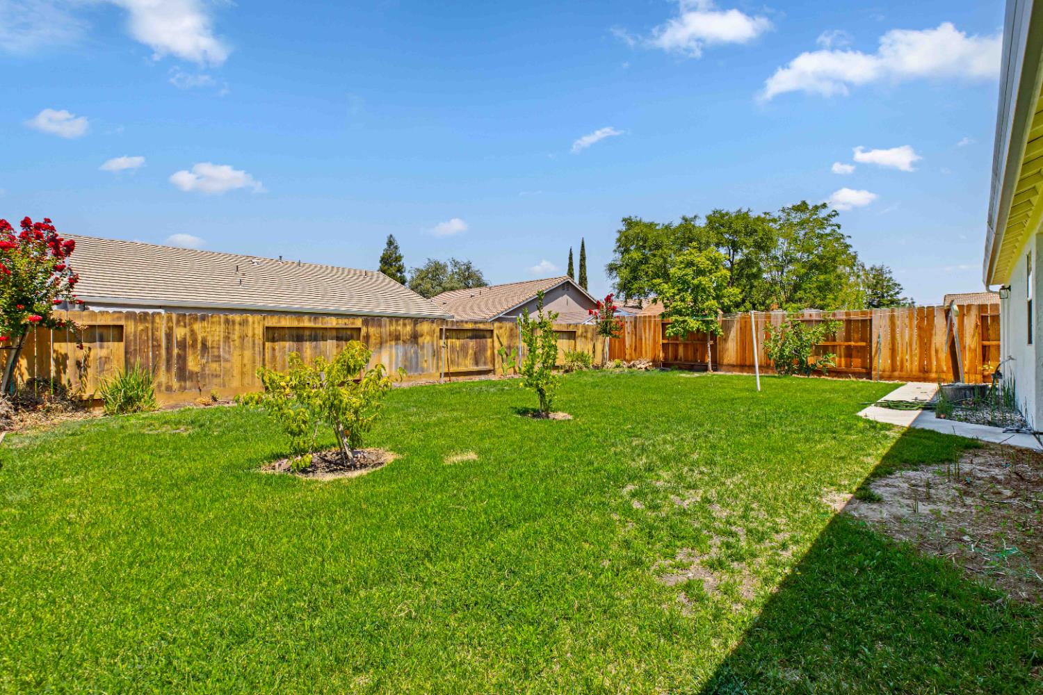 995 West Springer Drive Turlock, CA 95382 - Photo 33 of 39 a front view of a house with a yard table and chairs
