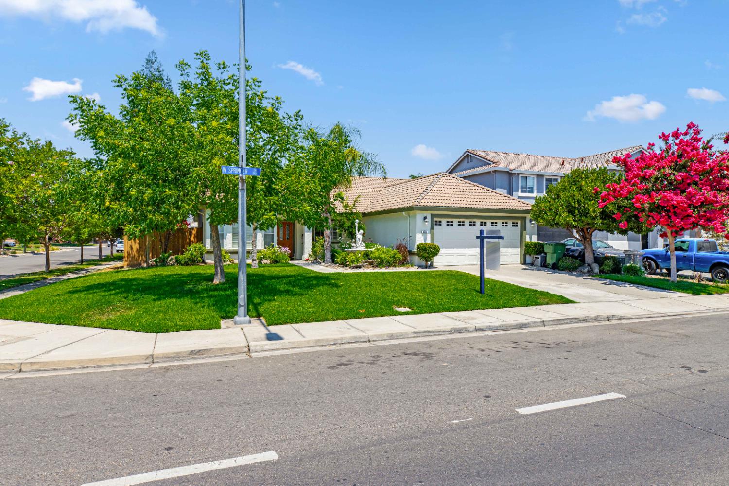 995 West Springer Drive Turlock, CA 95382 - Photo 4 of 39 a view of a house with a yard and table and chairs under an umbrella