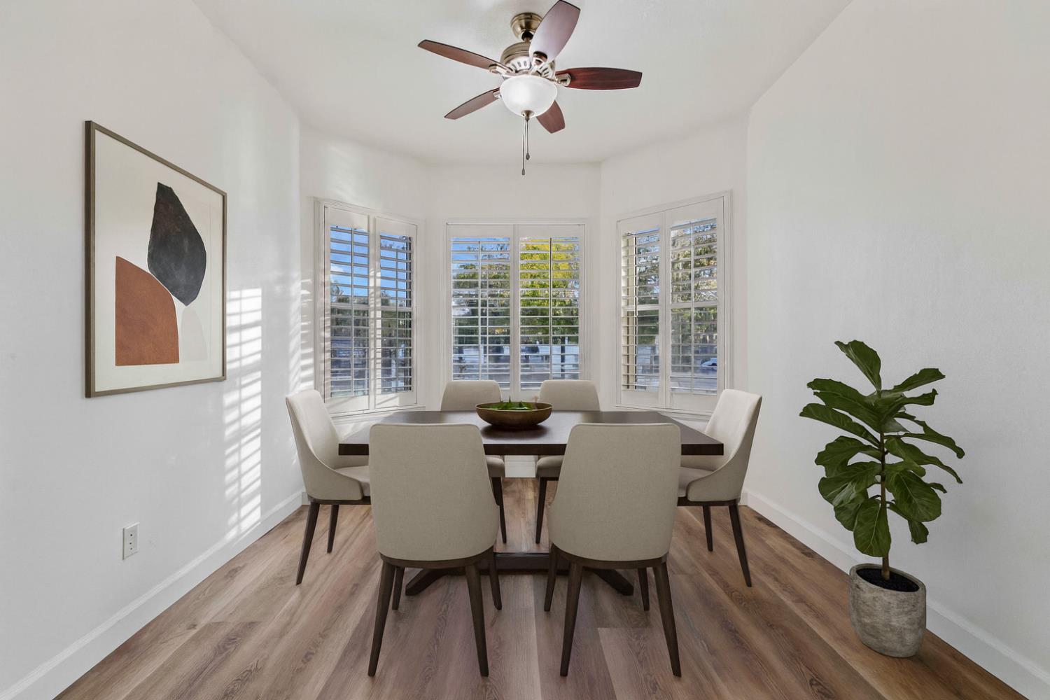 995 West Springer Drive Turlock, CA 95382 - Photo 9 of 39 a dining room with furniture potted plants and wooden floor