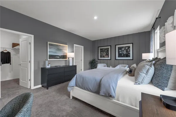 a bedroom with a bed and a dresser