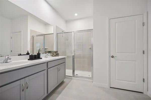 a bathroom with a double vanity sink and mirror