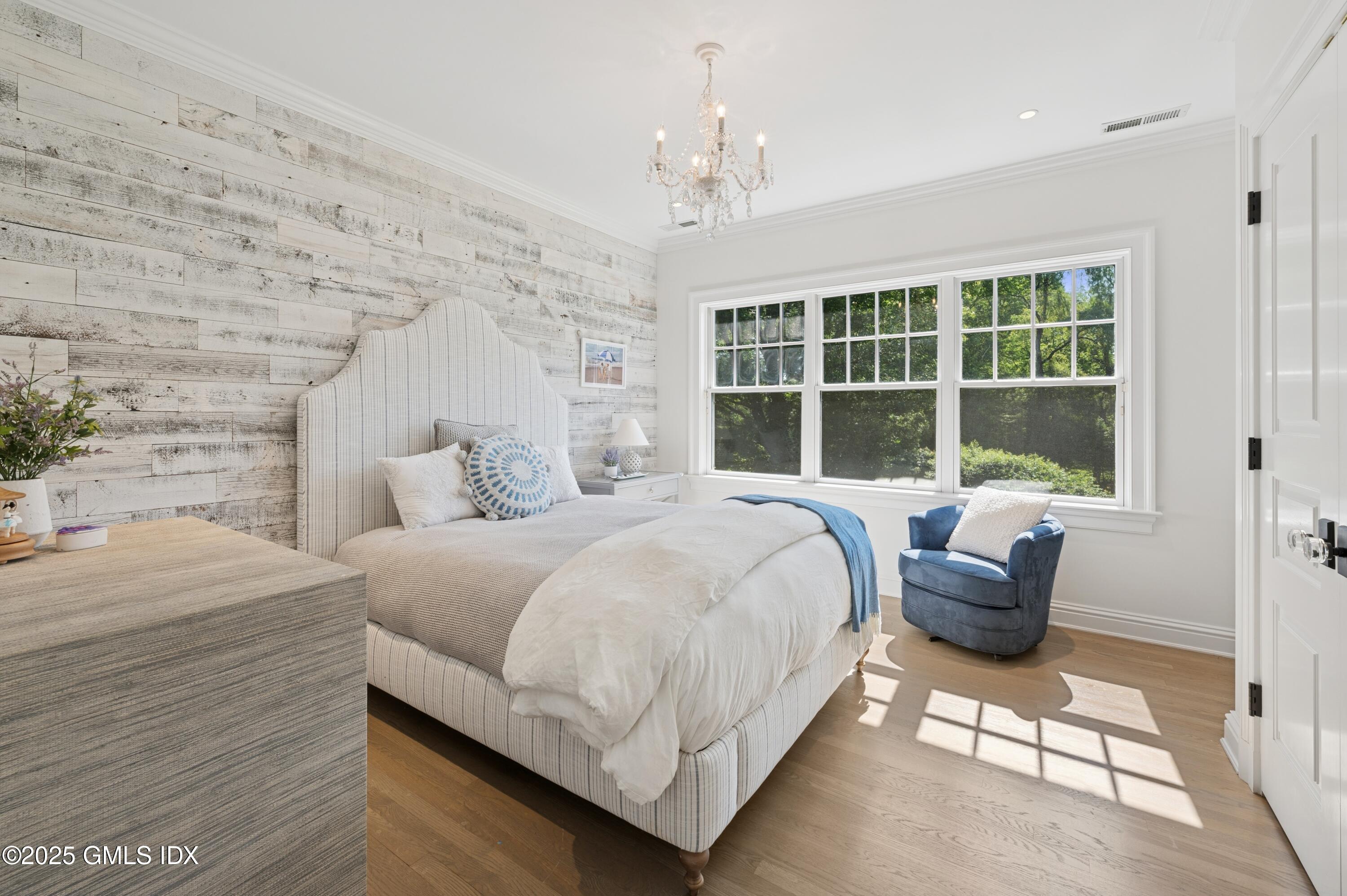 2 Sparrow Lane Greenwich, CT 06830 - Photo 18 of 28 a bedroom with a bed and a large window