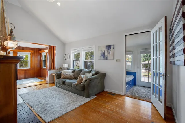 a living room with furniture rug and wooden floor