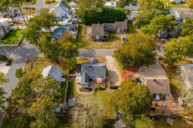 an aerial view of residential houses with yard